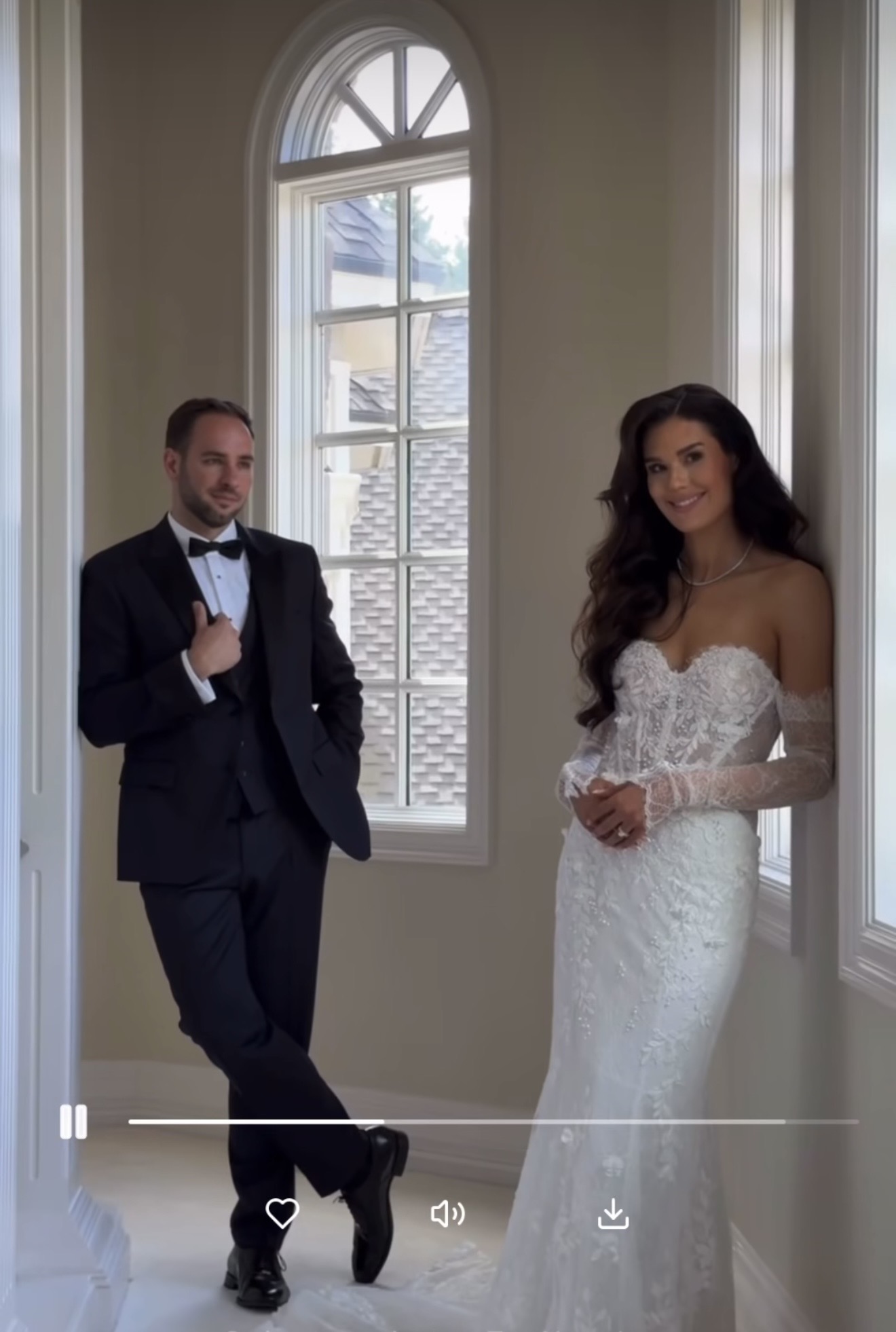 Bride and groom side by side in a sunlit hallway