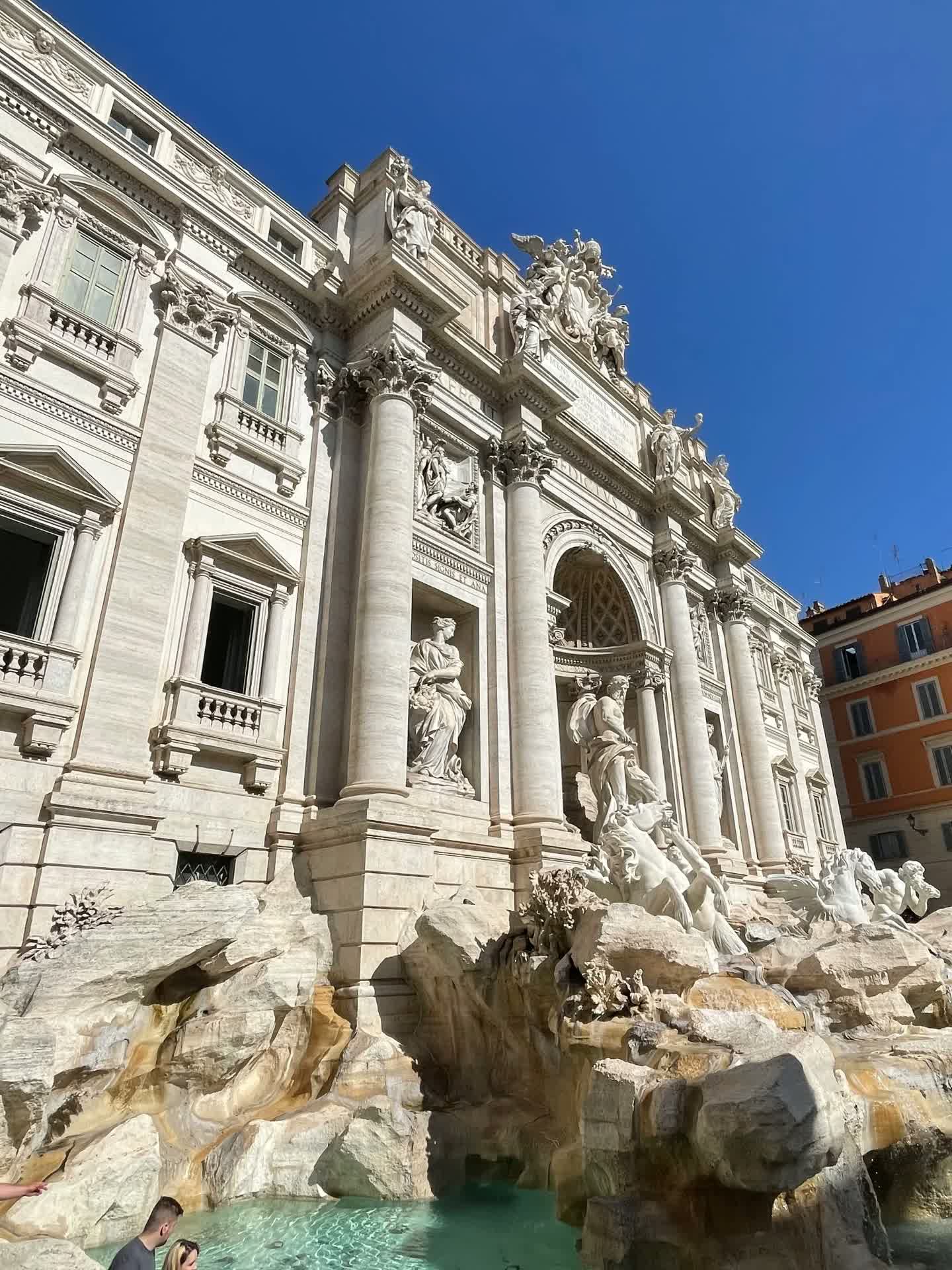 The Trevi Fountain in Rome under a clear blue sky