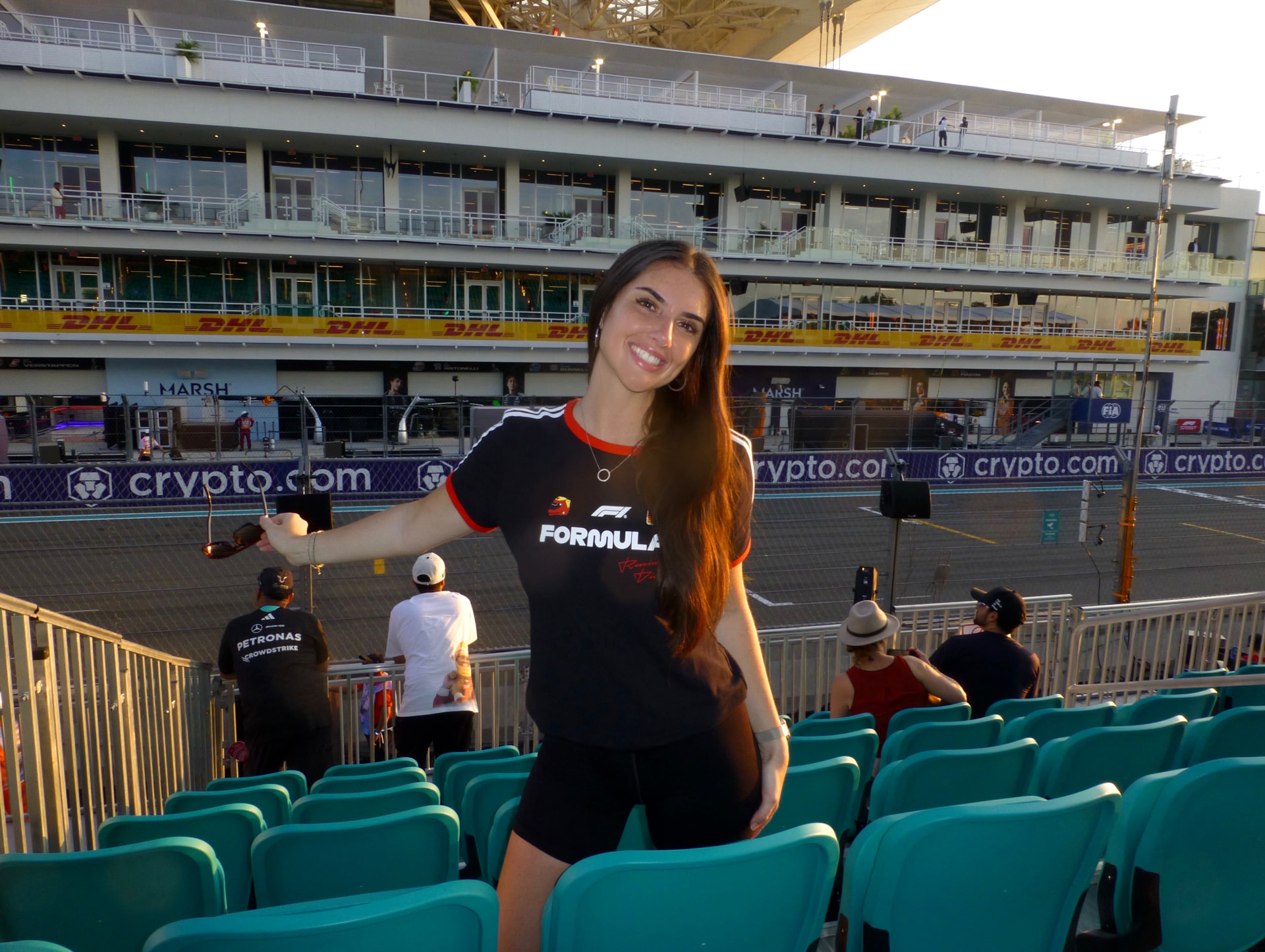 Lucia in a Formula 1 tee in the grandstands at the Miami Grand Prix