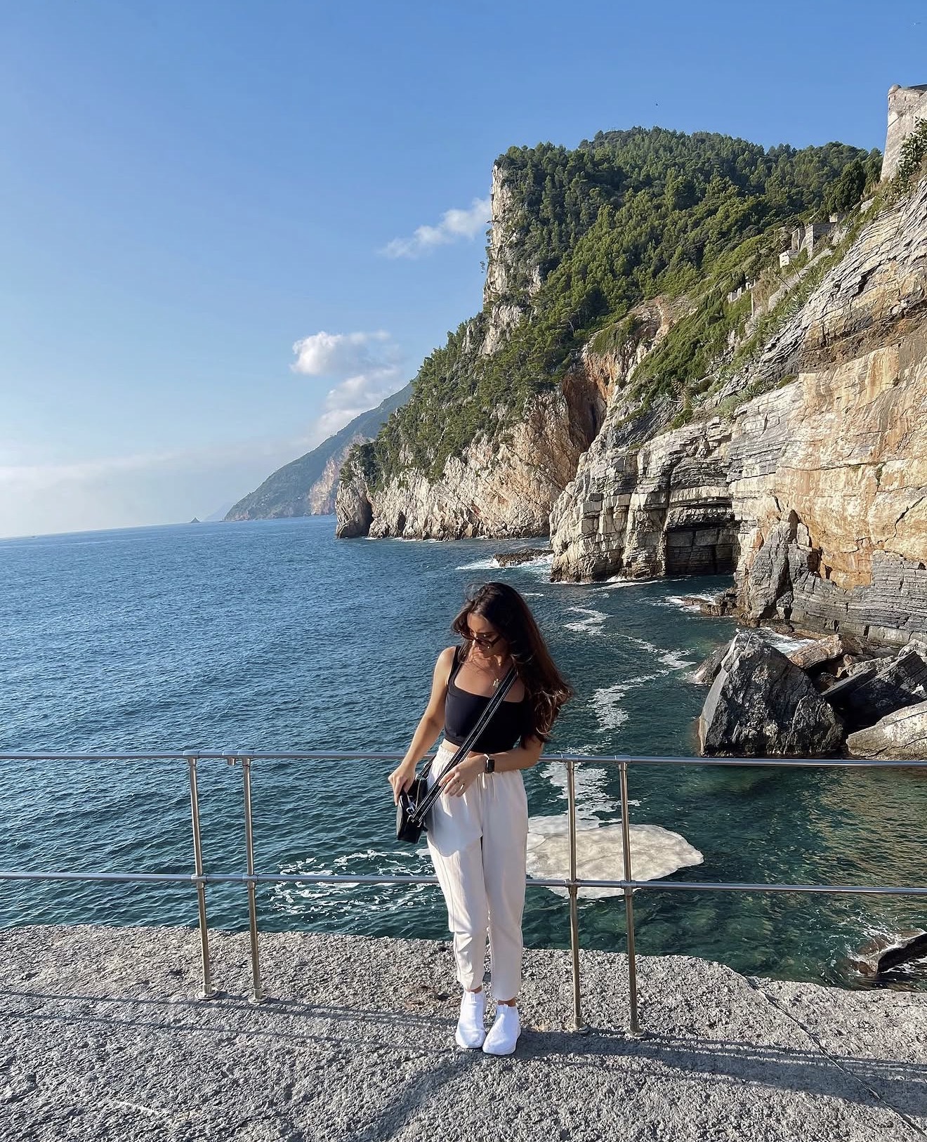 Lucia on the cliffside coastline in Portovenere, Italy