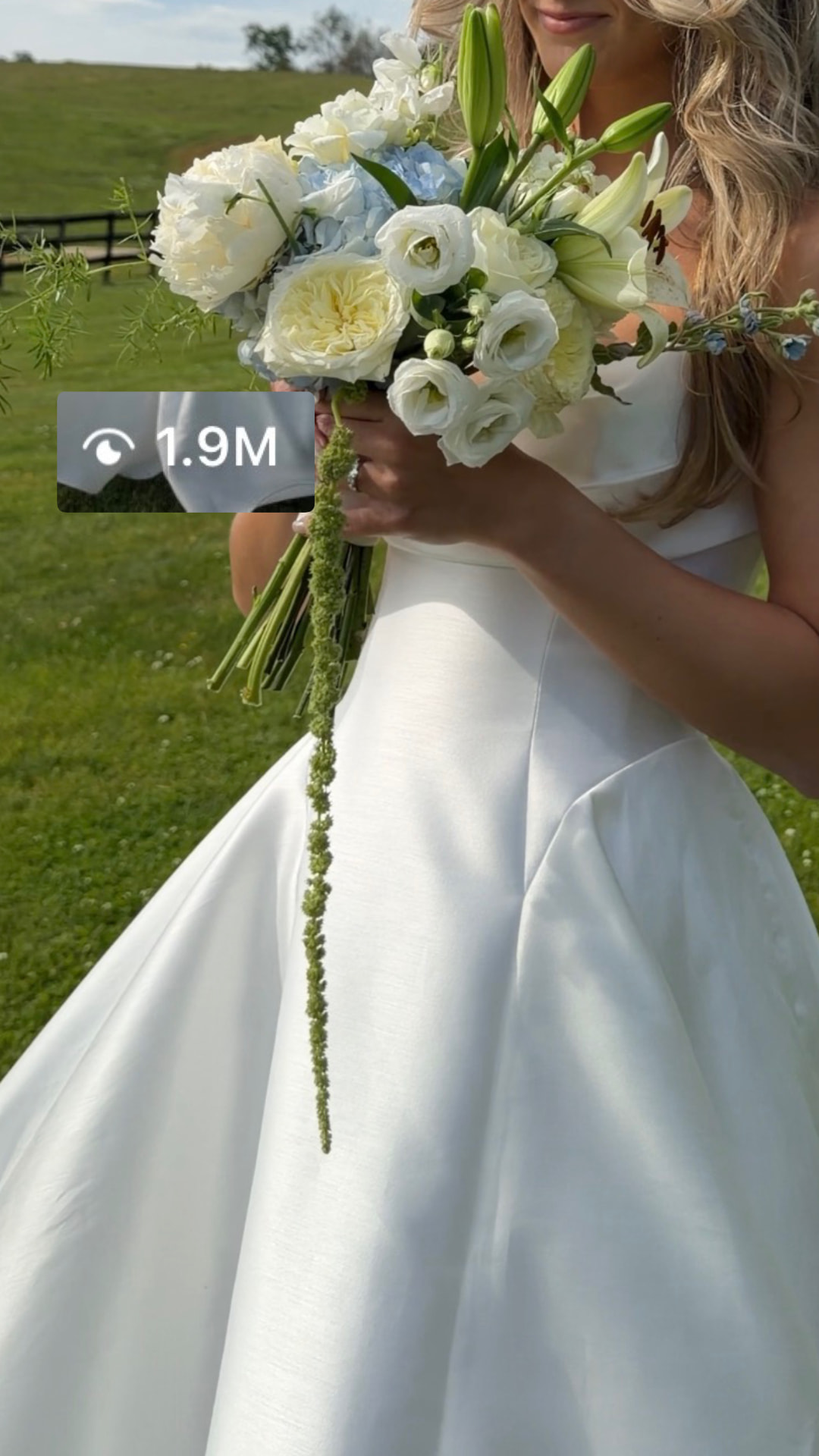 Bride holding her bouquet in an open field