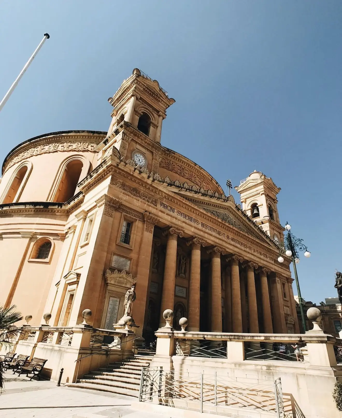 Domed church facade under a blue sky in Malta